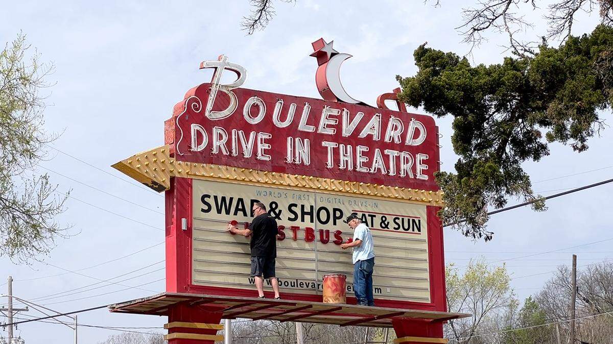 Boulevard Drive-In manager Brian Neal, left, and employee Craig Douglas spell out “Ghostbusters: Frozen Empire,” the theater’s first feature of the year which opens April 5.