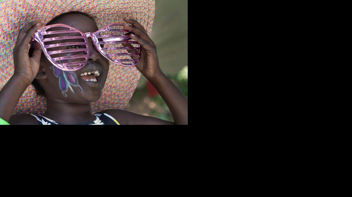 
Amany Hedgpeth, 7, of Blue Springs enjoyed a colorful game of dress-up with slightly-too-large glasses on Saturday at Niles Home for Children. Some 600 kids received toys donated by the Toy Industry Foundation at the event. 
