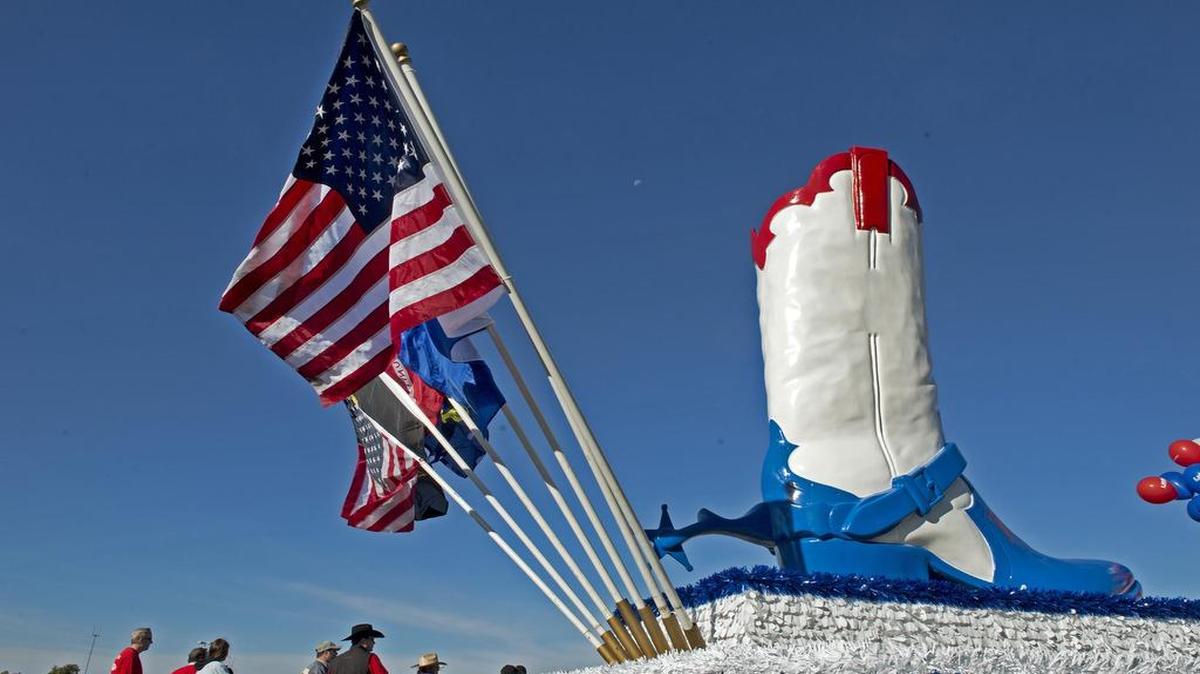 
The American flag fluttered in the breeze next to a giant cowboy boot on the UMB Bank float Saturday at the American Royal Parade at the Truman Sports Complex.

