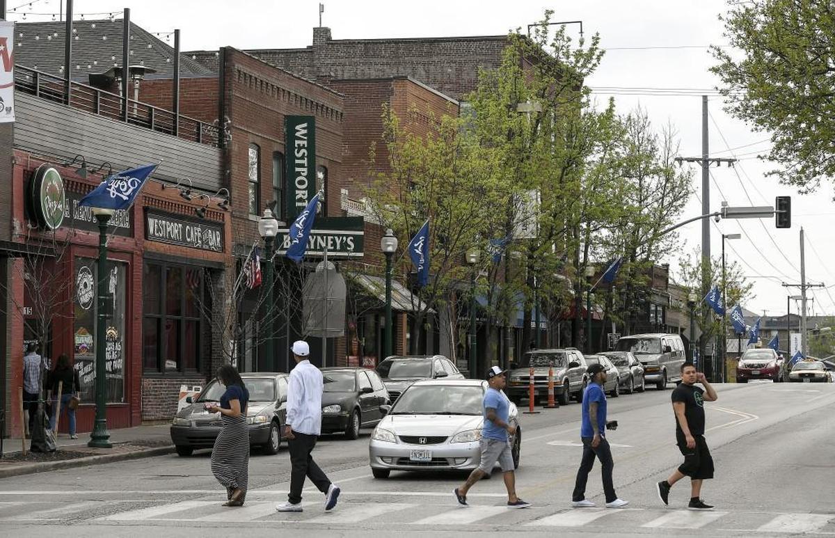 People walking near the intersection of Westport Road and Broadway Boulevard in Kansas City, Missouri.