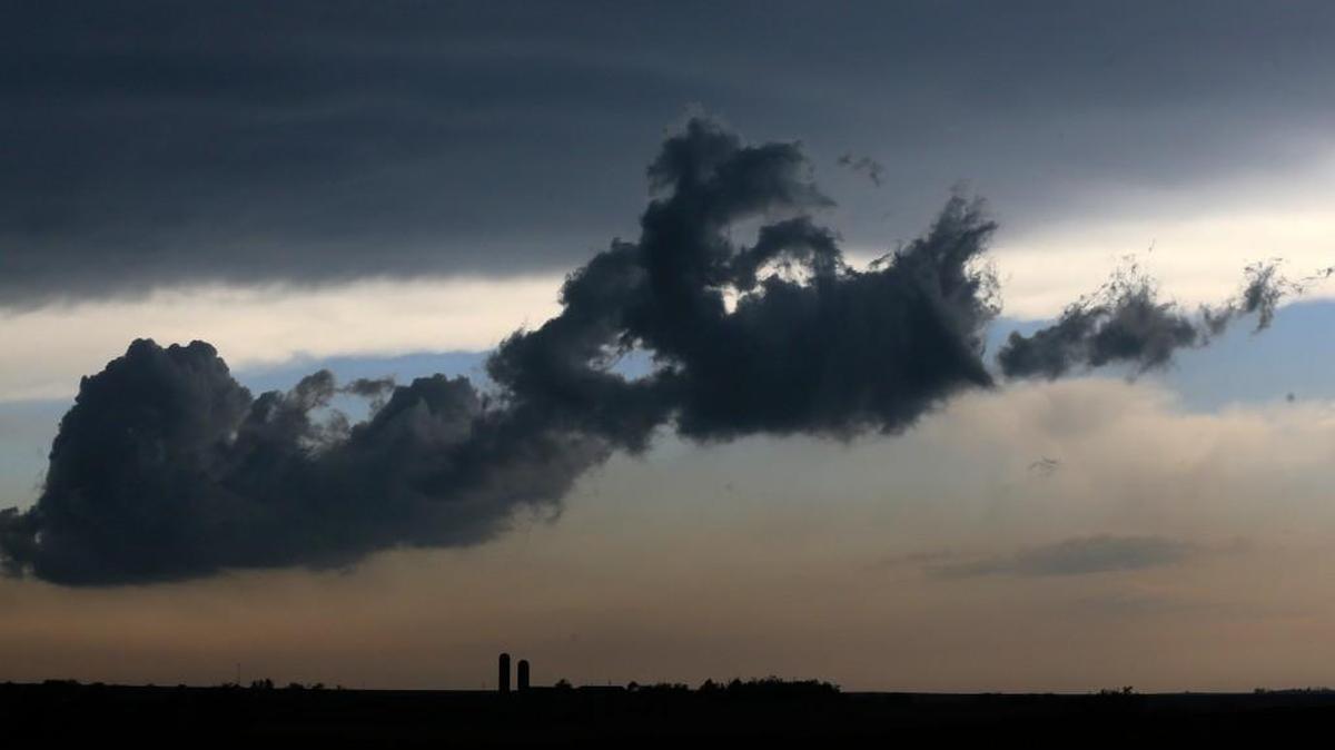 A low cloud moves over a farm near Gypsum, in central Kansas, Tuesday.