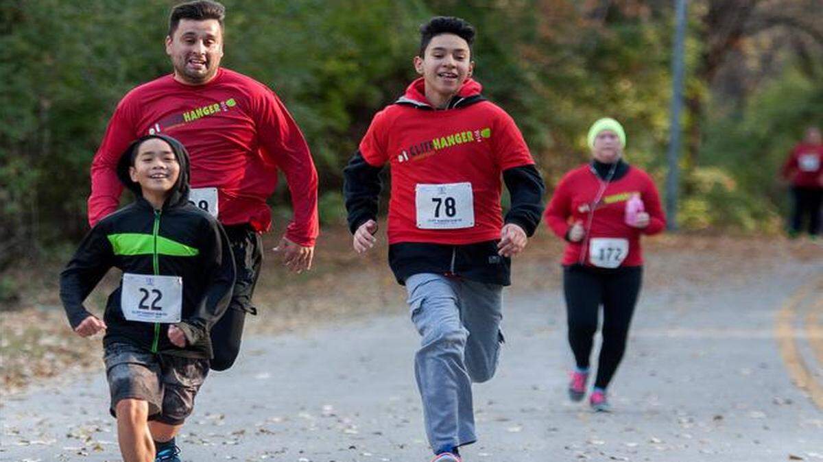 
Nick Pettit (upper left), a second-grade teacher at Scuola Vita Nuova charter school, ran to the finish line with seventh-graders Dinson Do (left) and Julian Ortiz in the 29th annual Cliff Hanger Run on Sunday. The Fit Doctors Association, a student organization at Kansas City University of Medicine and Biosciences, partnered with elementary school children from Scuola Vita Nuova, Garfield Elementary and Gladstone Elementary to train for the race.
