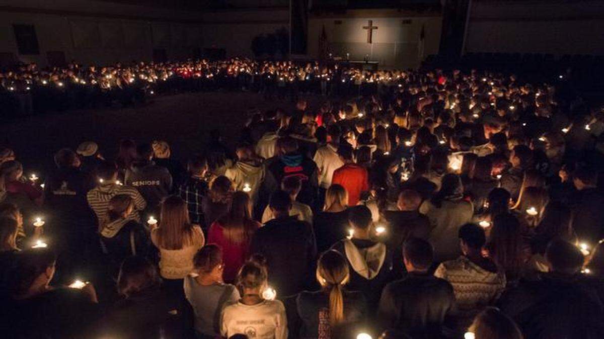 
People stood in a circle during a candlelight vigil at Grace United Methodist Church in Olathe on Tuesday held in remembrance of two Olathe Northwest High School juniors who committed suicide over the weekend.
