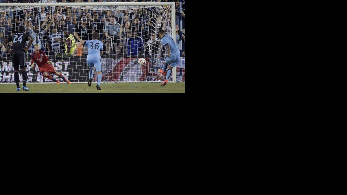 
Sporting KC goalkeeper Jon Kempin (21) goes to his right as Manchester City defender Aleksandar Kolarov (11) takes a penalty kick the other way to score in the second half during Wednesday's soccer game on July 23, 2014, at Sporting Park in Kansas City, Kan.
