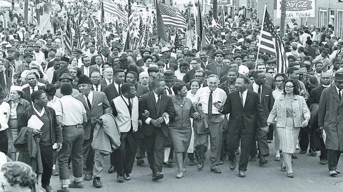 
Martin Luther King (third from right) led marchers across the Alabama River on the first of a five day, 50 mile march to the state Capitol at Montgomery, Ala., on March 21, 1965.
