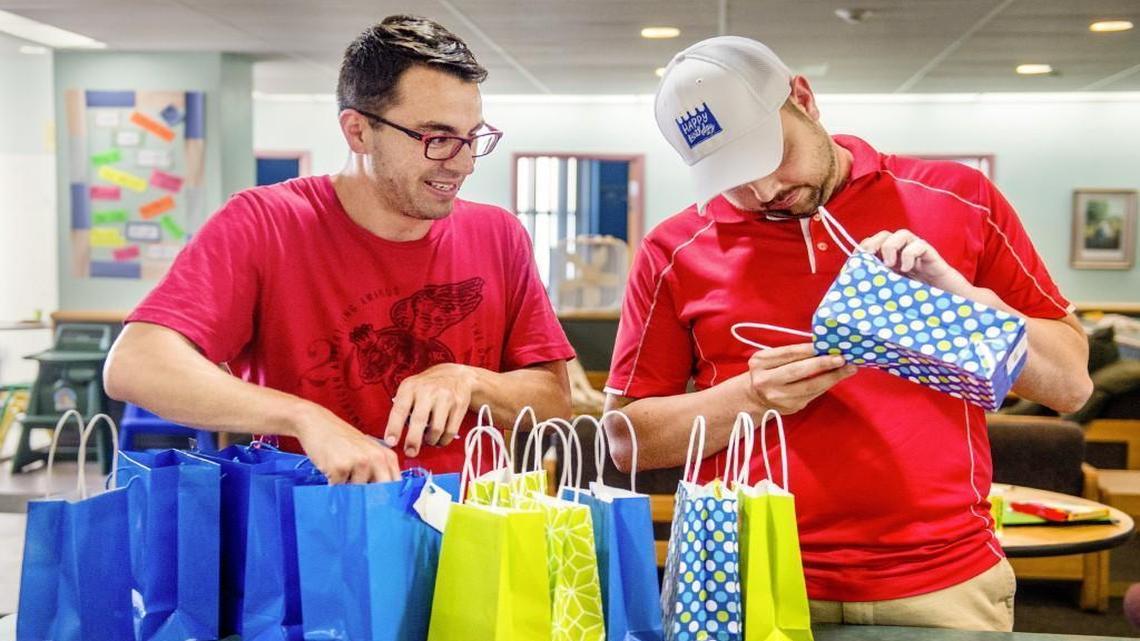 Nick Estrada (left), founder and CEO of Happy Birthday Inc., and treasurer Derek Dowell sort gift bags at the Salvation Army childen’s shelter in Kansas City. Happy Birthday Inc., which last month celebrated its first year in operation, provides birthday parties for area children who are in foster care.