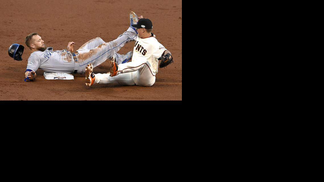 
Kansas City Royals left fielder Alex Gordon (4) tangles with San Francisco Giants second baseman Joe Panik (12) and is called safe in the third inning during Saturday's Kansas City Royals and San Francisco Giants Game 4 of the World Series at AT&T Park on Oct. 25, 2014 in San Francisco, California.
