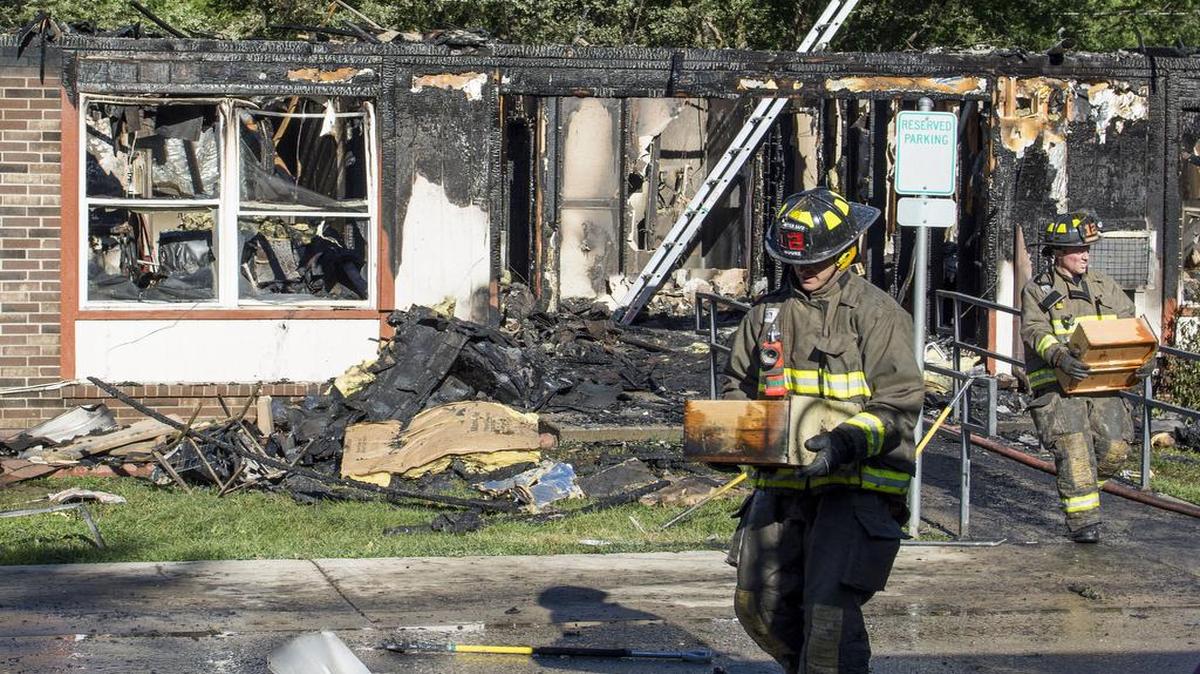 
Firefighters carried out a resident’s personal items after a fire damaged the Hillside Estates apartments in Smithville on Tuesday.
