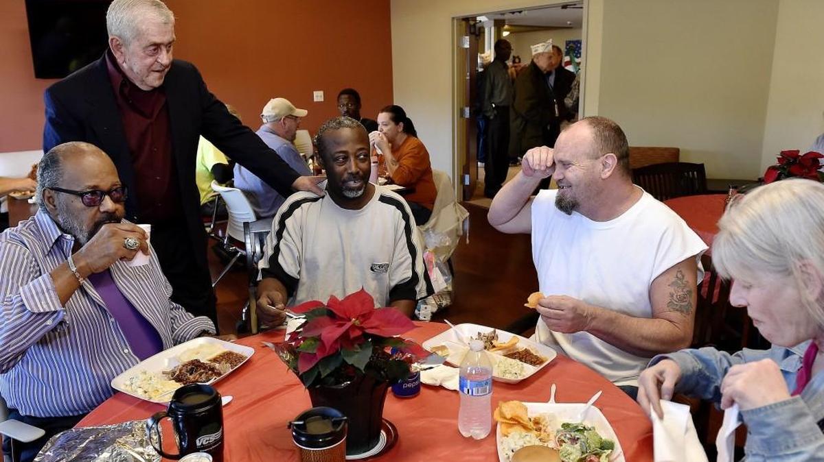 St. Michael’s residents and friends Cedrick Von Pumphrey (from left), Carl Yonkers, Robert Green and George and Lisa Grigsby chatted at a holiday party last month.