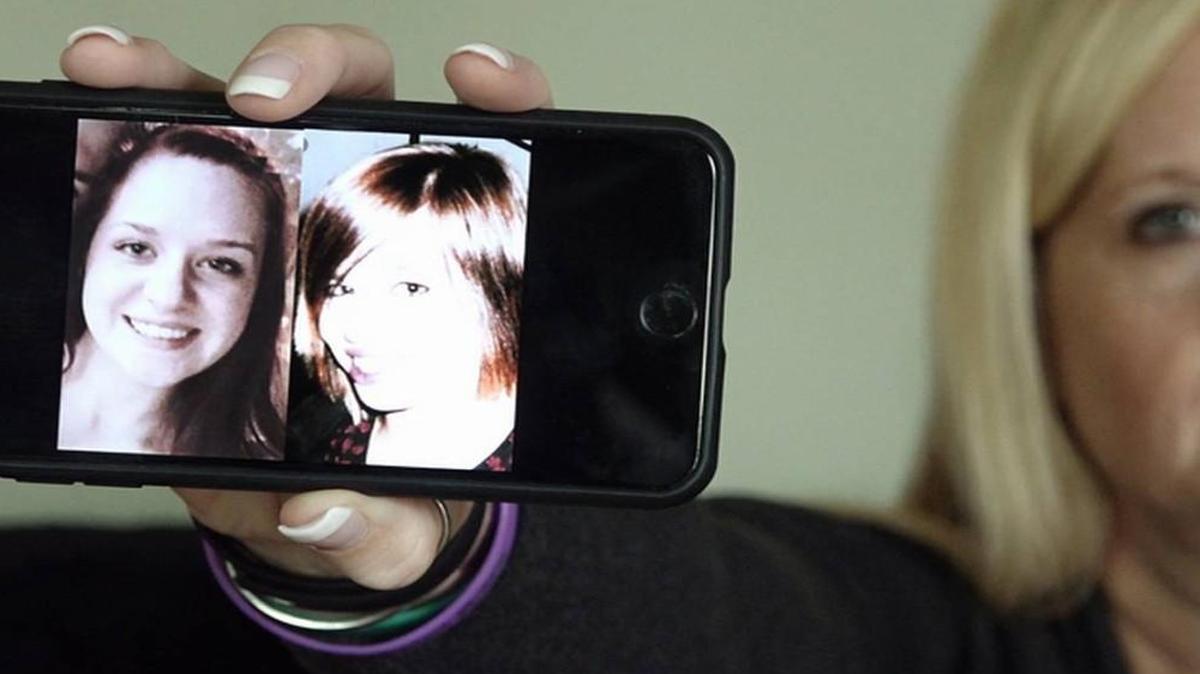 Jamie Runions holds a cell phone with images of her missing daughter, Jessica Runions (left), and Kara Kopetsky. Two sets of human remains were found last week in Cass County, one of which has been positively identified as Jessica Runions.