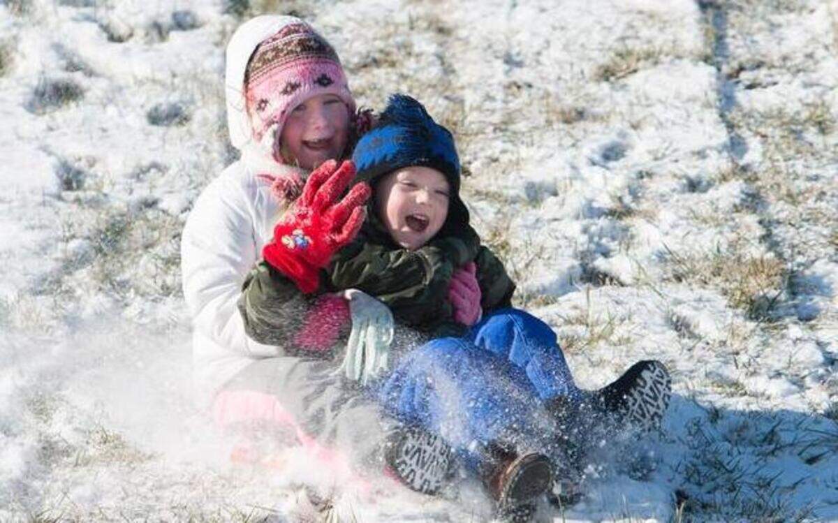 
Frigid temperatures did not keep Mikayla Laughlin, 6 (back), and Kollin Jones, 4, both of Belton, from having some fun Sunday sledding downhill in the fresh small amount of snow. The families were taking breaks and sitting in their cars in between runs to help keep everyone warm.
