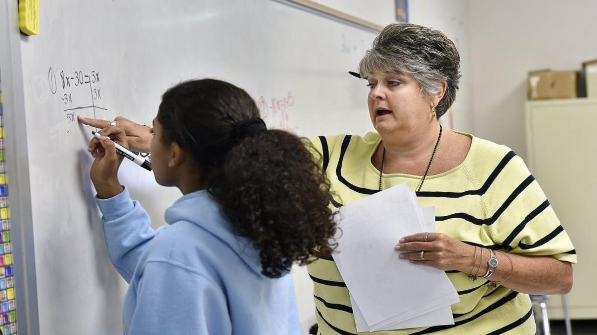 
Algebra teacher Ritchey Lowe helped Emma Rose with an exercise. All eighth-graders at Martin City Middle School take algebra. 
