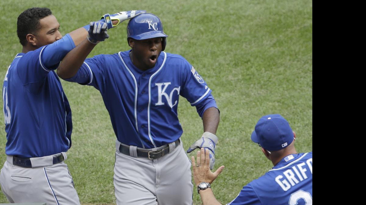 
Kansas City Royals' Lorenzo Cain, center, celebrates with Salvador Perez, left, and catching coach Pedro Grifol after hitting a solo home run during the sixth inning of a baseball game against the Chicago White Sox Sunday, July 19, 2015, in Chicago. 
