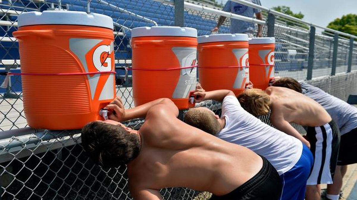 
At a football camp Tuesday at Rockhurst High School in Kansas City, boys entering fourth through ninth grades worked on skills out on the field where rubber pellets made physical exertion an even sweatier task. Everyone was given a water break every 15 minutes or as needed and finished up practice with water as well.

