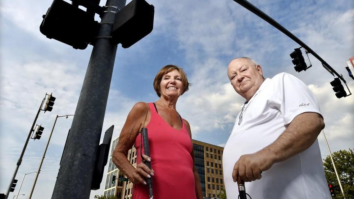 Keith Spare (right), president of the South Plaza Neighborhood Association, and Francie Hall, who is legally blind and lives in the neighborhood, are opposed to the removal of the traffic signals now operating at 49th and Main Streets. The developer of the nearby Board of Trade building is pushing for the lights to be removed.