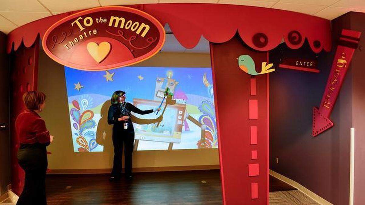 
As they prepared Wednesday for Thursday’s opening of another Ronald McDonald House, the Wylie House, at 2525 Cherry St., CEO Holly Buckendahl (center) and Megan Neher checked out its shadow puppet theater.
