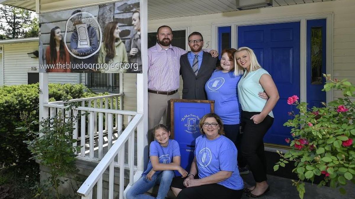 Laura Drescher (back row, right) and husband Bryan Drescher (back row, second from left) were inspired by Aubri Thompson (between the Dreschers) to create the Blue Door Project for foster kids. Seated in front were Addison Stephenson-Roy, 9, and Carla Drescher, Bryan’s mother. Standing at far left was Matthew Brungardt, a son-in-law of Carla Drescher.