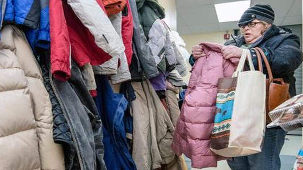 
Patricia Malone looked for donated coats in her size Tuesday at the Salvation Army Community Center in Independence. An anonymous church donated 29 coats to the Salvation Army, which began giving them out Tuesday to needy people. “It came at the right time with the cold the way it is,” said Salvation Army Maj. Dean Towne, who added that the organization continues to look for donations.

