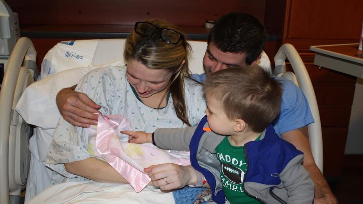 Suzanne and Cory Ozbun, with son Sam, spend time with baby Ellie, who was stillborn on Christmas Eve 2015.