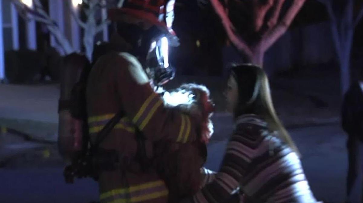 A firefighter reunited a woman with her dog after a house fire Thursday night in the 5300 block of West 158th Place.