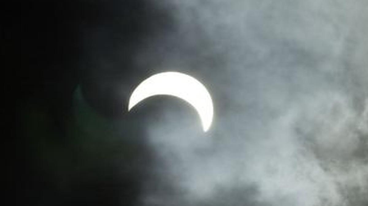 
A crescent sun is seen as the marine layer moves by during a partial solar eclipse on June 10, 2002, in San Diego.
