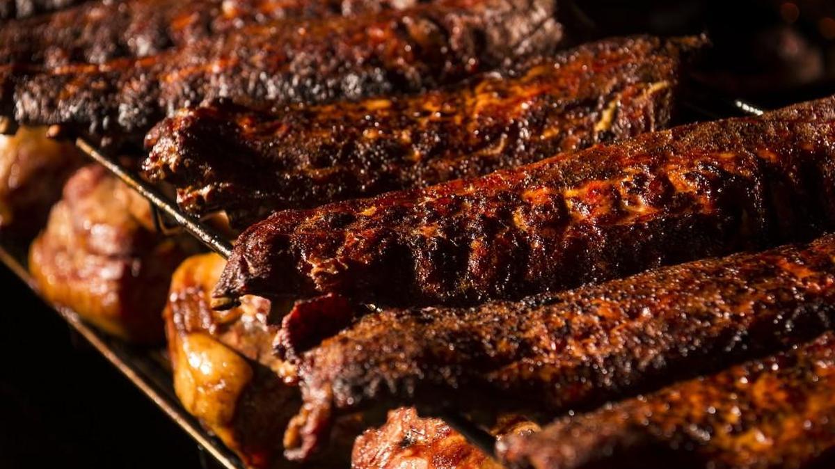 Ribs cook on a smoker carousel at the Freight House location of Fiorella’s Jack Stack Barbecue in Kansas City.
