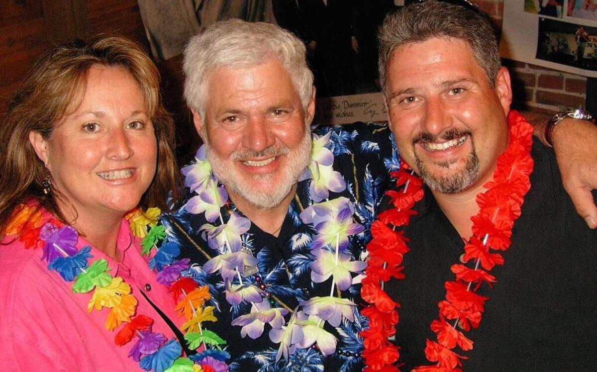 Del Dunmire (center) celebrated his 70th birthday party in 2004 with children Debra Dunmire Hedenkamp and Mark Dunmire. Now, six months after their father’s death, the siblings may clash in court over who is the rightful heir to the Dunmire fortune.