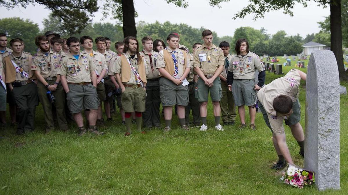 
At the tombstone for Theodore and Belle Naish in an Edwardsville cemetery, Tom Ward placed flowers Sunday as Boy Scouts remembered the couple’s connection to Camp Naish.

