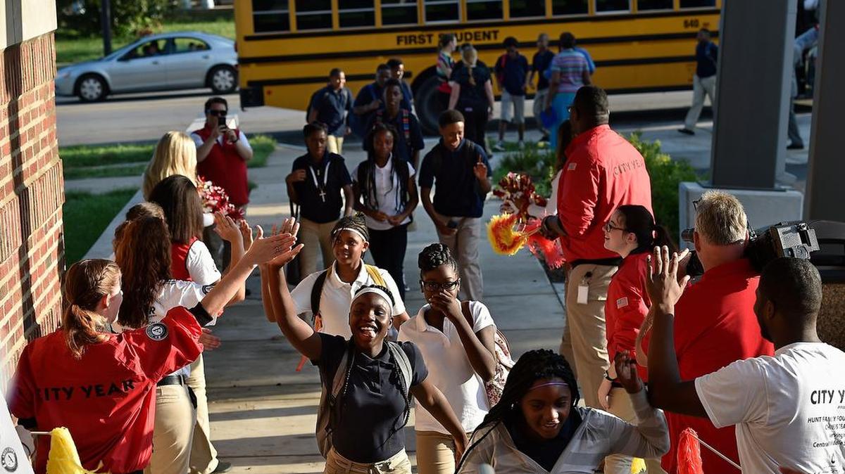 
Students arriving at Central Middle School, 3611 E. Linwood Blvd., on the first day of school were enthusiastically greeted by City Year members, Chiefs cheerleaders, KC Wolf, and Chiefs Rumble Monday, Aug. 10, 2015. Eighth grader Catherine Carter (left) high fives a City Year member on the way in.
