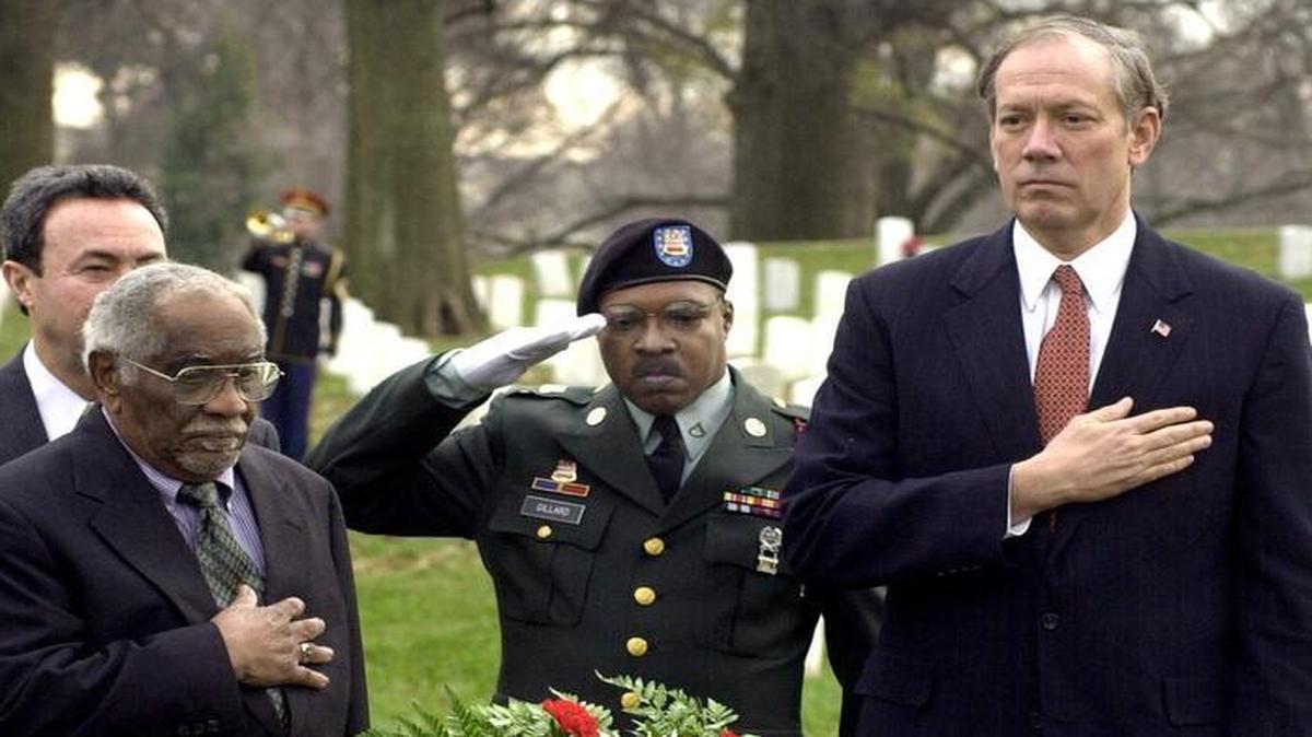
In 2002, Herman Johnson (left) joined then-New York Gov. George Pataki (right) in a moment of silence after placing a wreath at the grave of Henry Johnson at Arlington National Cemetery in Arlington, Va. Herman Johnson died in 2004 believing he was Henry Johnson’s son, but the U.S. Army has told his daughter that there is no relation, despite the family stories.
