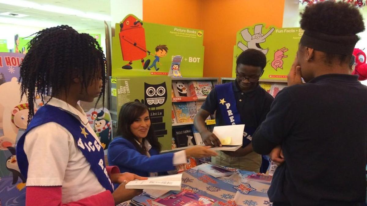 Angela Cervantes, a children’s book author, signed books Thursday for students at Benjamin Banneker Elementary School, where a My Very Own Library book giveaway was launched in Kansas City.
