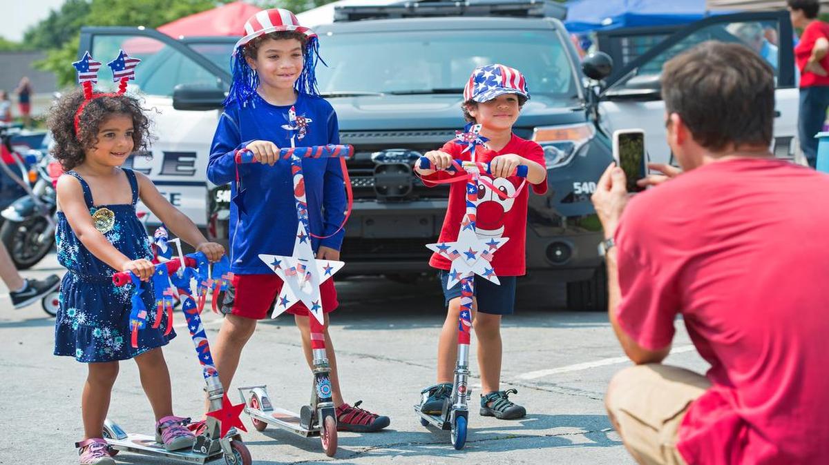 
After they rode their decorated scooters in the Fourth of July VillageFest bike parade in Prairie Village, Chris Jehle photographed his children — Amara (from left), 3, Chase, 6, and Cooper, 3.

