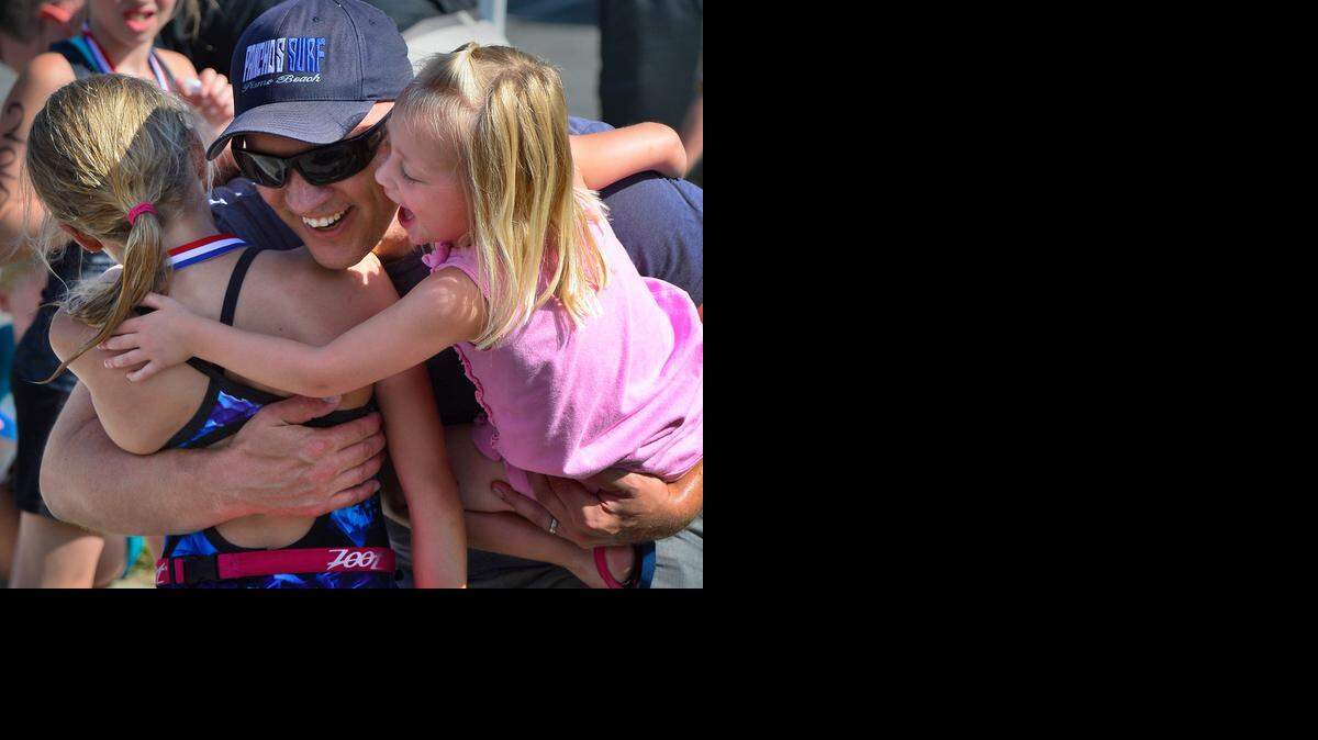 Dave and Aven McFather congratulated Reese McFather (left) after the Kids Triathlon in Gladstone on Saturday.