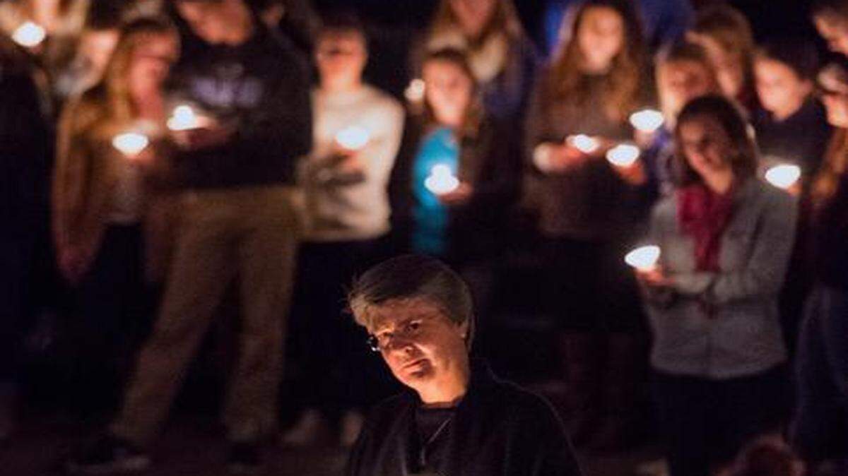 
The Rev. Nanette Roberts listened Tuesday to a speaker during a candlelight vigil at Grace United Methodist Church in Olathe, held in remembrance of two Olathe Northwest High School juniors who committed suicide.
