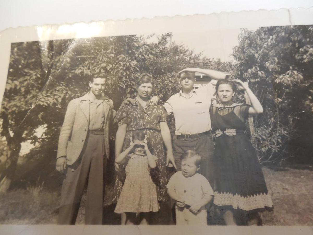 Shortly before he left for the war, Donald Tolson (far left) with his mother, brother and brother’s wife and children.
