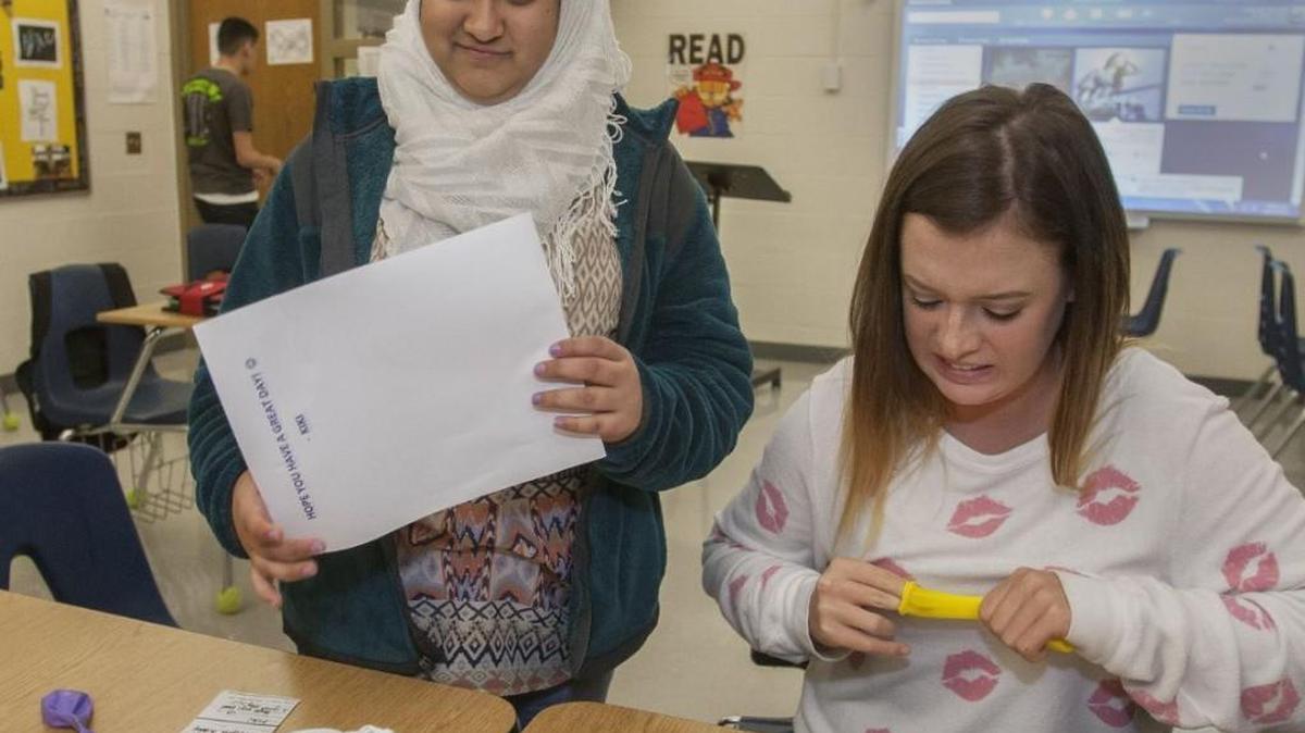 Blue Valley North peer mentor Courtney Stallard (right) and Ifraa Iftikhar, a student in the connections class, prepared balloons for a Halloween party last fall. The high school was ranked No. 1 in Kansas by U.S. News & World Report.