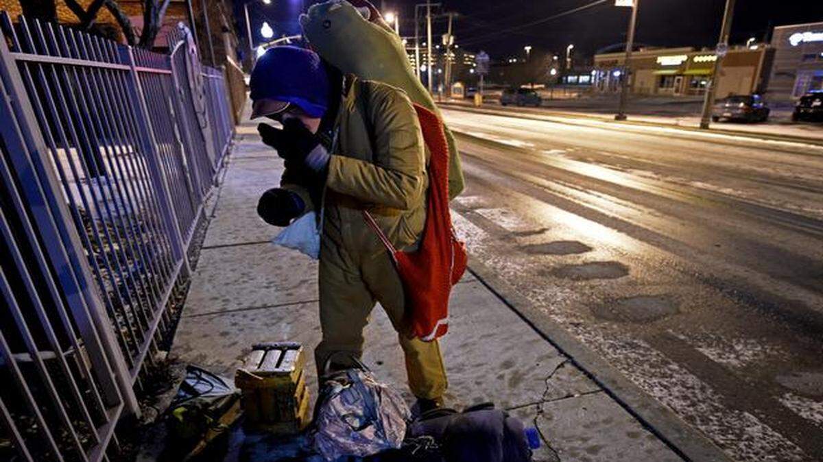 
After spending Tuesday night outside, Joel Hinson, who is homeless, gathered his belongings and made his way to a grocery store in Westport to warm up. He paused along the way to warm his hands from the bitter cold. Hinson said he dresses in layers and when he can get them, uses hand-warmers in his socks to stay as warm as he can overnight.
