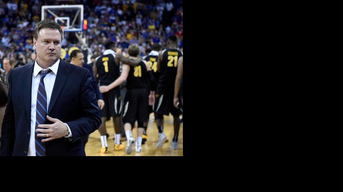 
Kansas coach Bill Self made his way off the court as Wichita State players (rear) celebrated their 78-65 NCAA Tournament win over the Jayhawks Sunday in Omaha.
