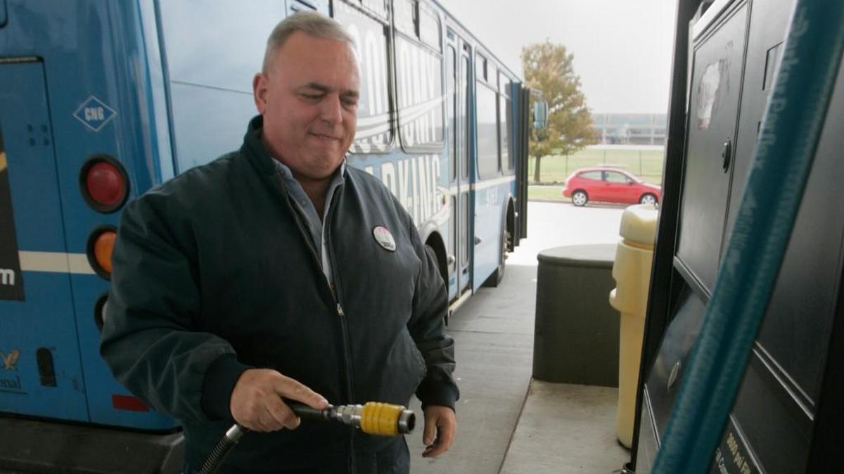 A shuttle driver refueled his bus with natural gas at Kansas City International Airport.
