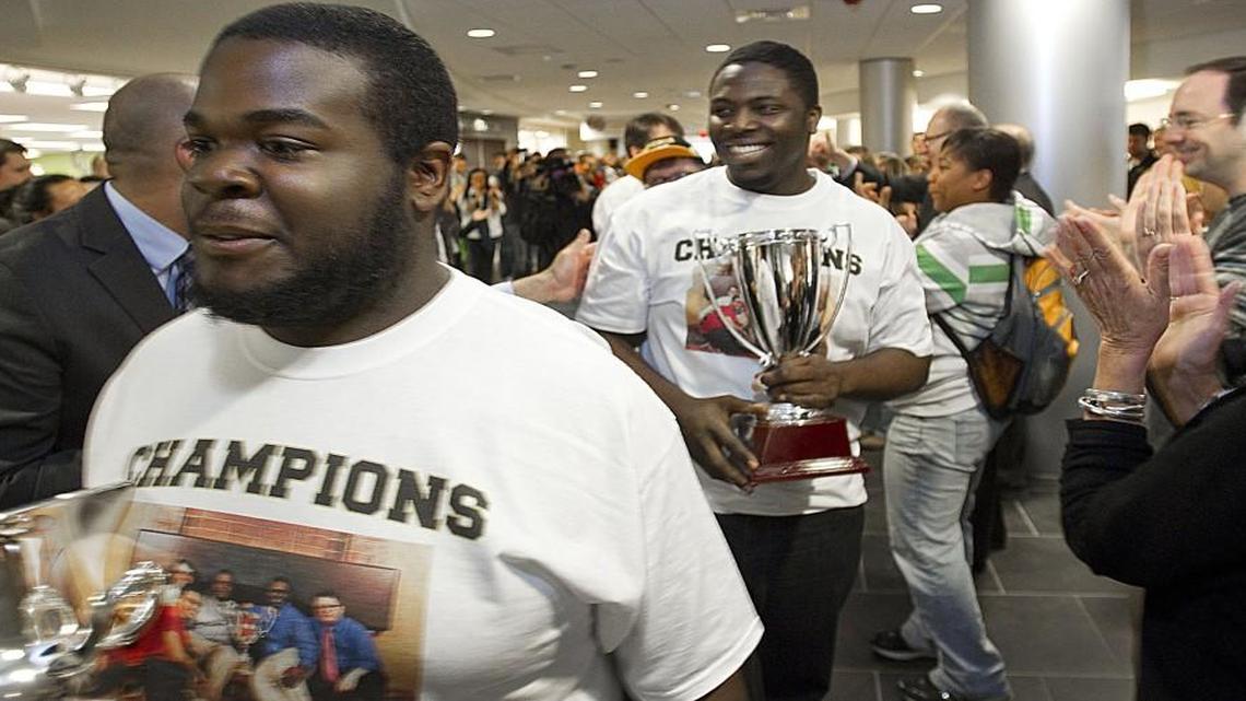 In April 2013, Emporia State University students cheered and clapped as Elijah Smith (left), of Newark, N.J., and Ryan Wash (right), of Kansas City, displayed their trophies and handed out high-fives during a student parade to celebrate two national debate titles won in one week by Wash and Smith.