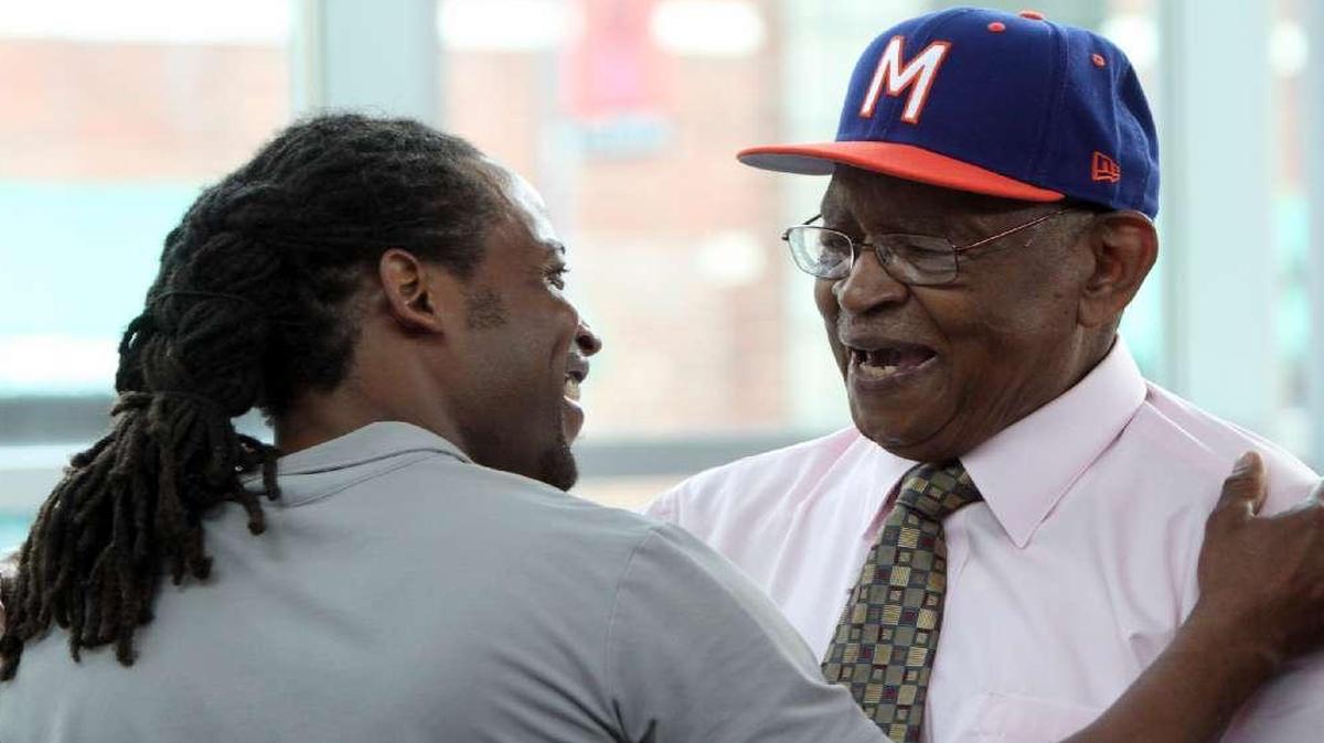 Don Motley (right) greeted DeVon Glover of Overland Park, one of his former players, when the Ban Johnson Baseball League was host to a celebration at the Negro Leagues Baseball Museum in 2013 that paid tribute to Motley. Motley, a driving force behind the Negro Leagues Baseball Museum and an amateur baseball coach in Kansas City for nearly 60 years, died Sunday morning at 89.