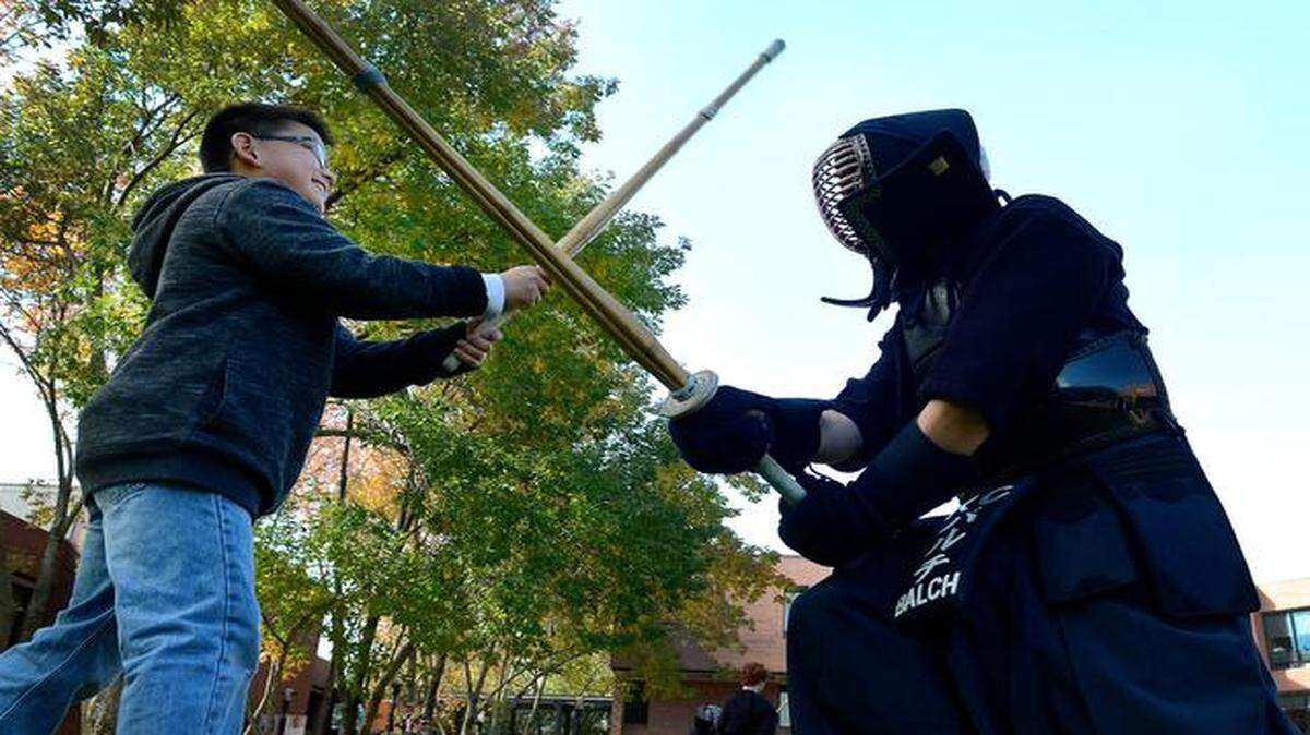 
Aiden Reese (left), 11, took a turn sparring with James Balch, a member of the Kansas City Kendo Club, during Saturday’s Greater Kansas City Japan Festival at Johnson County Community College.
