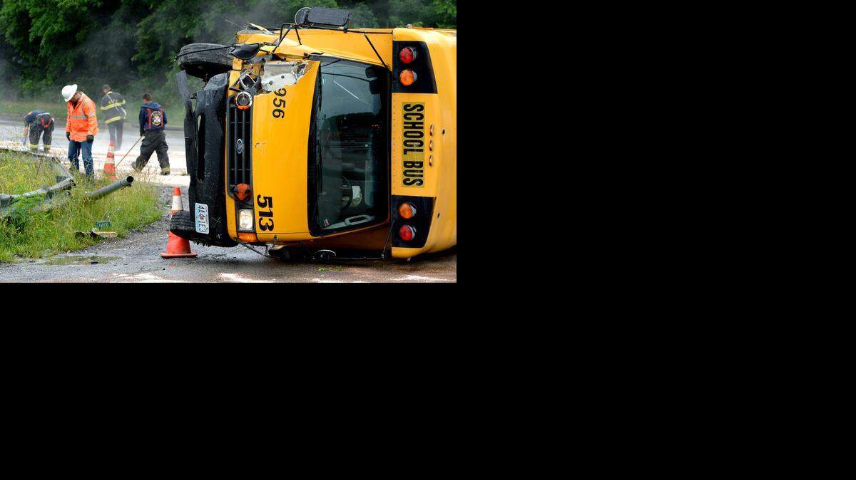 
A small school bus turned over Thursday morning in the northbound lanes of Blue Ridge Cutoff as it approached Raytown Road. The driver and a monitor were injured, but two children on board were only shaken up. Kansas City firefighters put an absorbent material on fluid that leaked from the bus as KCP&L workers worked the area that affected a street light pole and power lines.
