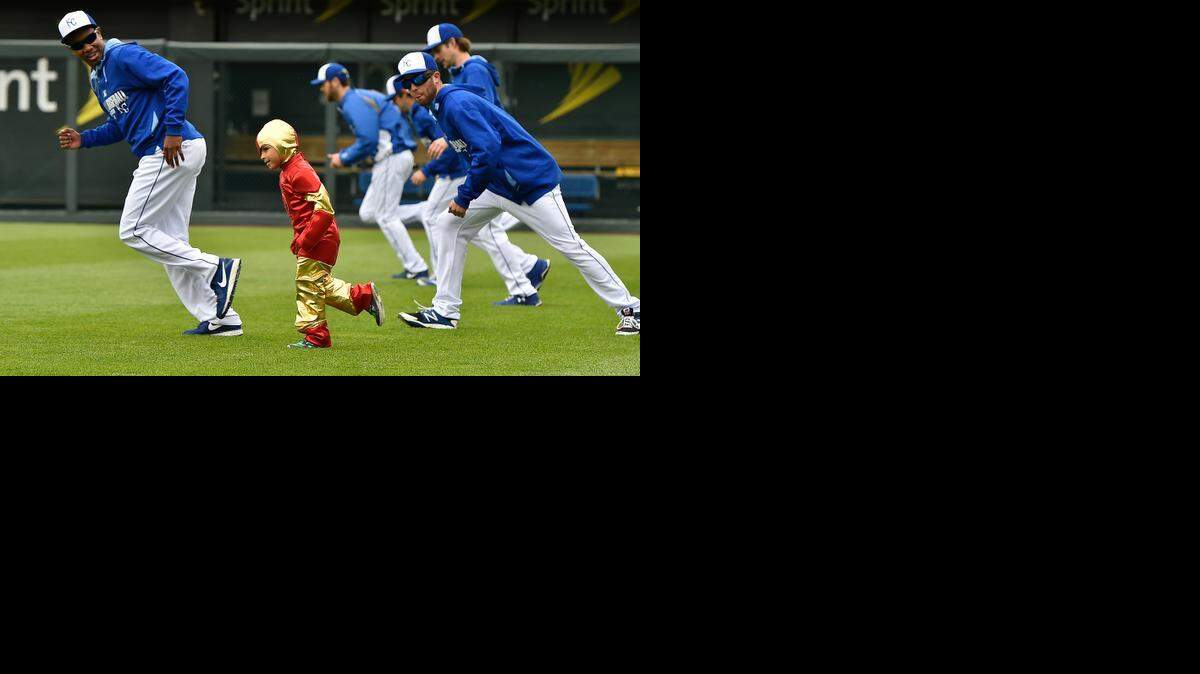 
After bravely rescuing Sluggerr, who had been tied to a pole, Isai Rojas put Royals pitcher Yordano Ventura (left) through his paces at Kauffman Stadium on Friday before the team’s game. 


