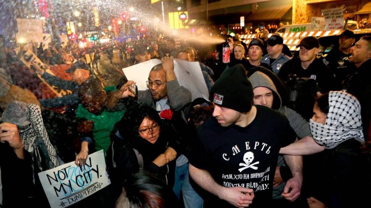 Police pepper-spray a crowd of protesters and journalists outside GOP presidential hopeful Donald Trump's rally Saturday evening in downtown Kansas City. Images of police using pepper spray in another arrest drew criticism from activists.