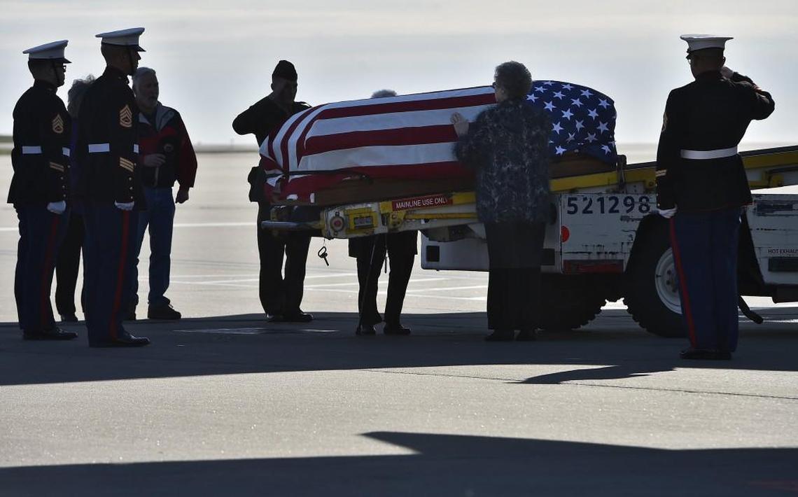 After 74 years, the remains of Marine PFC Donald Tolson was returned to his family, arriving at KCI on Dec. 1. Tolson’s first cousin, Judy Klinginsmith of Chillicothe, Mo., places her hand on the casket as the Marines stand by. Tolson was killed in action in the Battle of Tarawa in World War II.