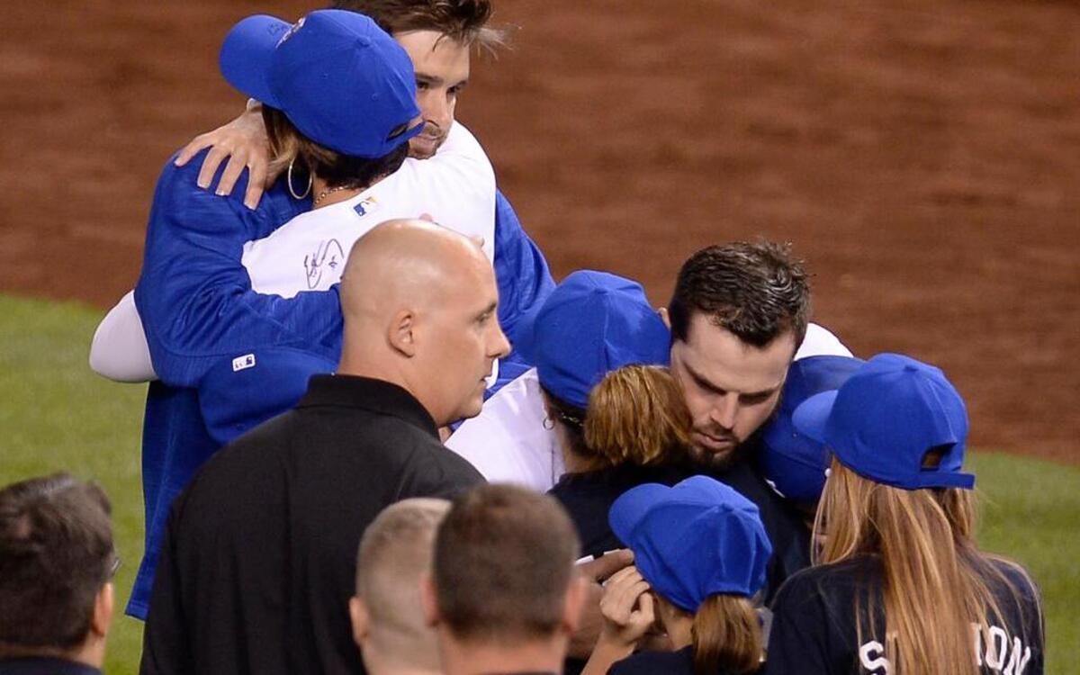 
Kansas City Royals third baseman Mike Moustakas hugged members of firefighters’ families during Wednesday’s game at Kauffman Stadium.



