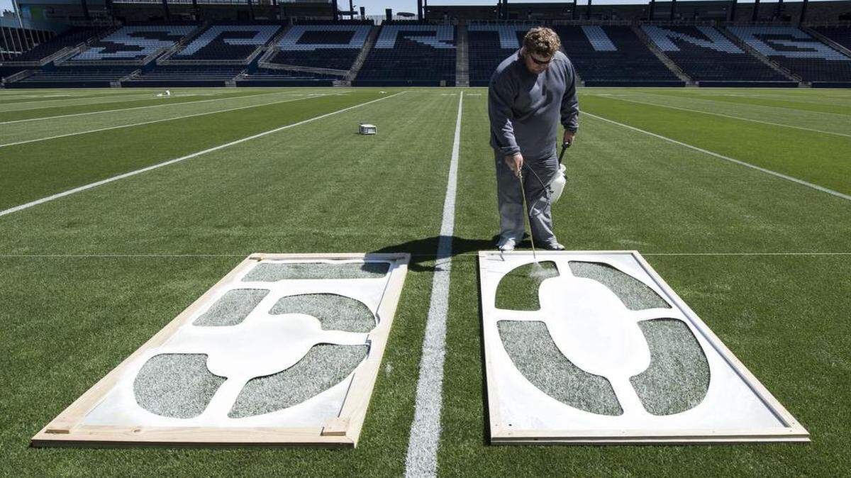 
Justin Bland, head grounds keeper, stencils numbers onto the field while transforming the soccer pitch at Sporting Park into a football field on Wednesday, April 22, 2015, in Kansas City, Kansas in preparation for Saturday's Kansas State University spring football game. Due to construction, K-State's spring game was moved from Bill Snyder Family Stadium to Sporting Park. Gates will open at 1 p.m. and the game kicks-off at 3 p.m. on Saturday.
