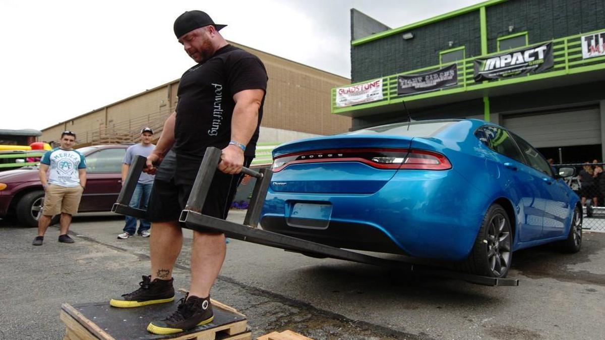 
Ben Moore of Kansas City, a member of the Impact Elite Powerlifting Team, hoisted a Dodge Dart on Saturday at the Fight Circus pro/am MMA event.


