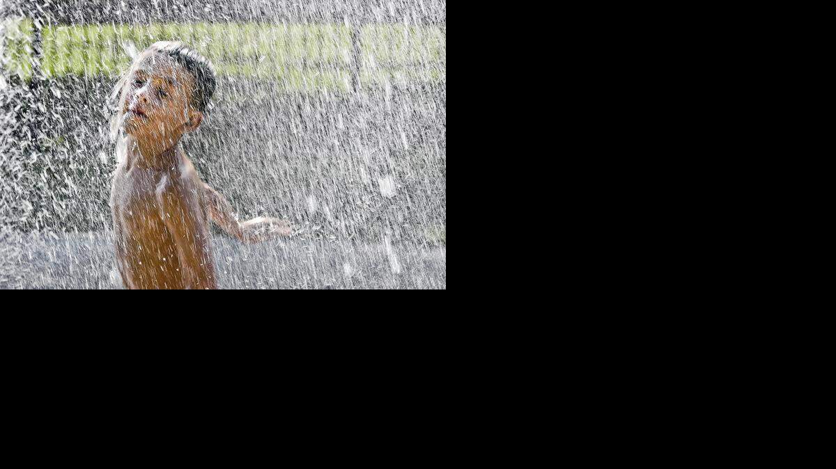 
The heat on Tuesday, Aug. 19, bought plenty of people to the Loose Park Spray Park in Kansas City to cool off including 6-year-old Teddy Zitron, of Kansas City, running through one of the fountains.
